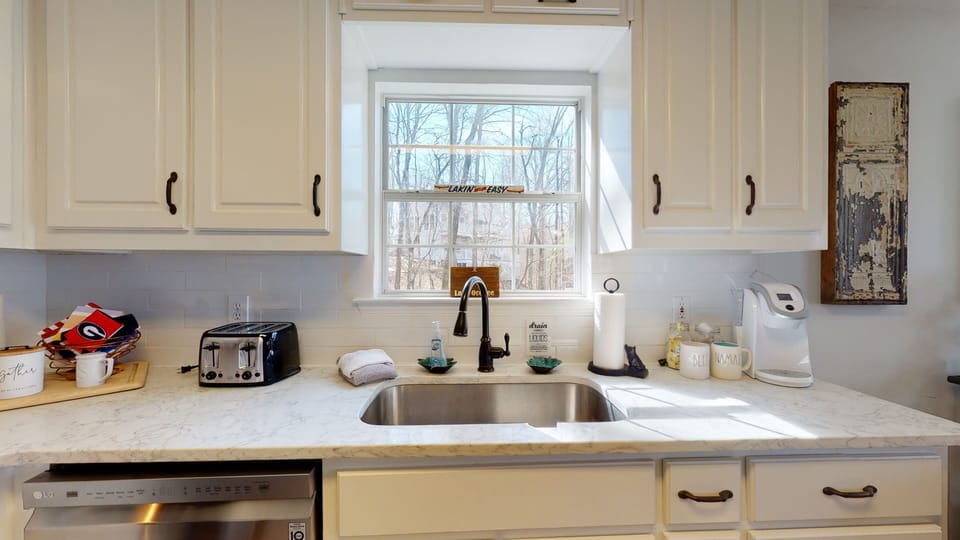 full stocked renovated kitchen with Keurig and plenty of dishes, pots pans 