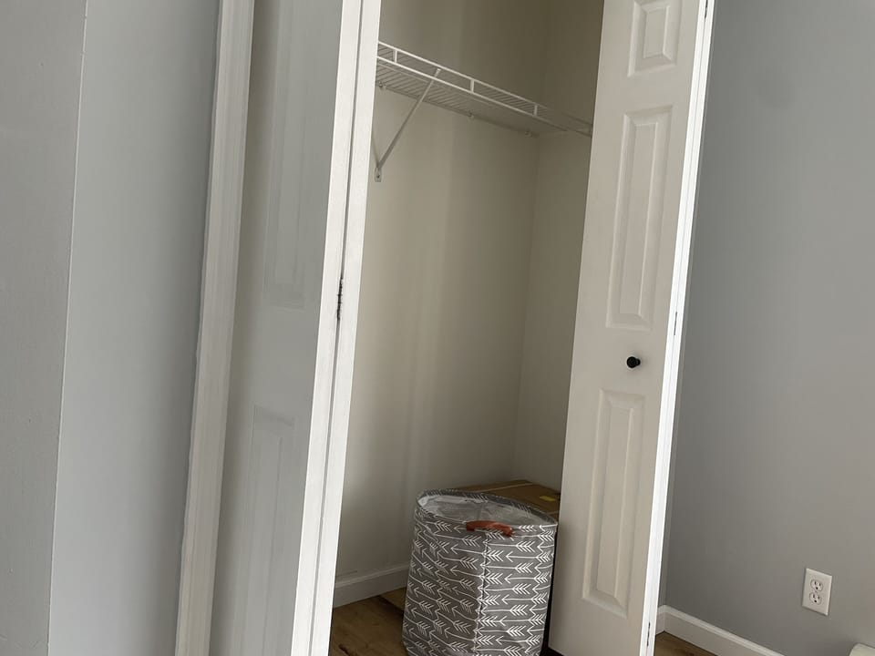 closet of bedroom 1. Includes hangers, hamper and pack n play.