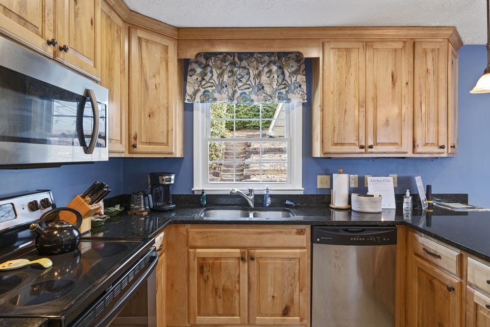 modern kitchen with granite top and SS appliances and all needed utensils