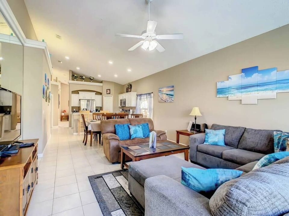 Stretch out in the bright and airy living room with plenty of cozy seating.
