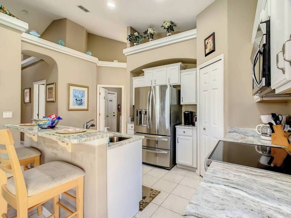Whip up delicious dishes in this sleek kitchen featuring stainless steel appliances.