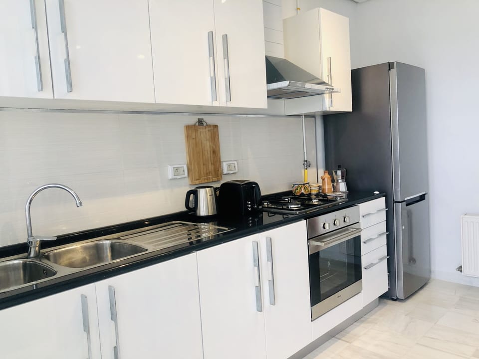 Modern and well equipped kitchen with a big fridge, stove ...