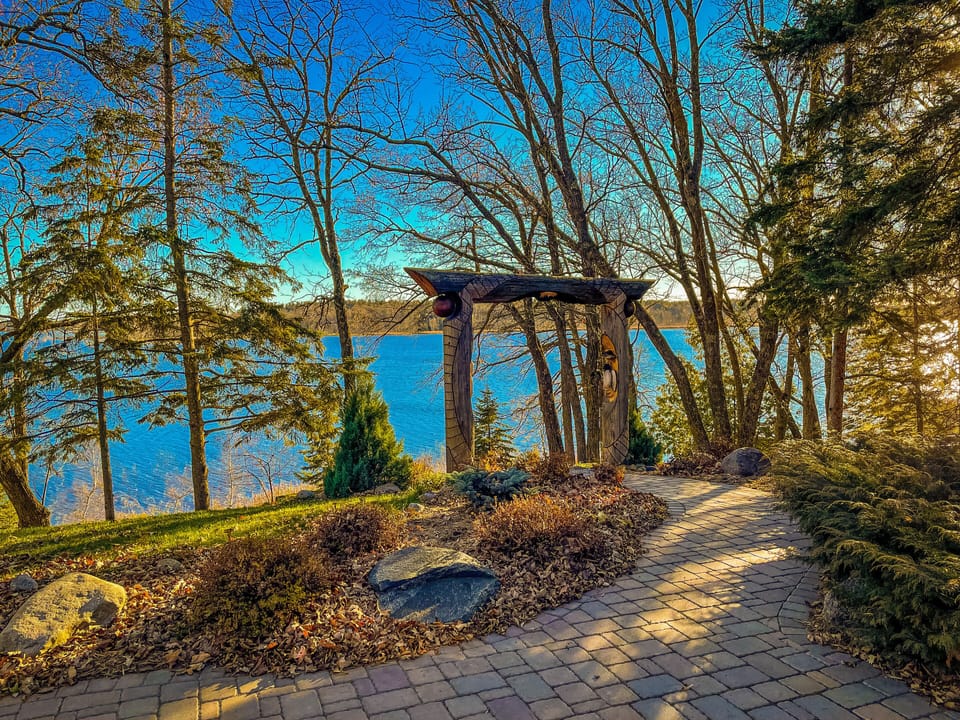 View from the screened in porch. Gradual, paved path down to the water.