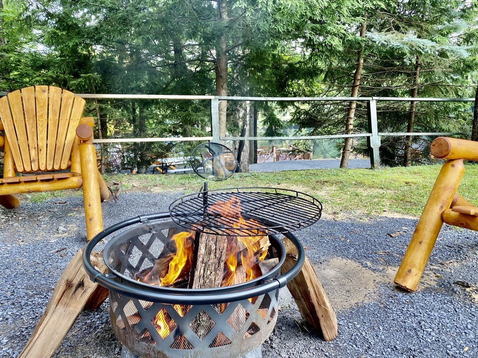 Fire pit with cooking grate outside the cottage