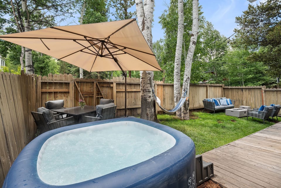 Fenced private yard with hot tub, BBQ, dining and lounging