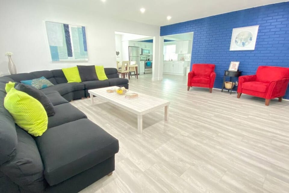 Roomy, stylish, and modern living room with plenty of comfortable seating for large families and a smart TV