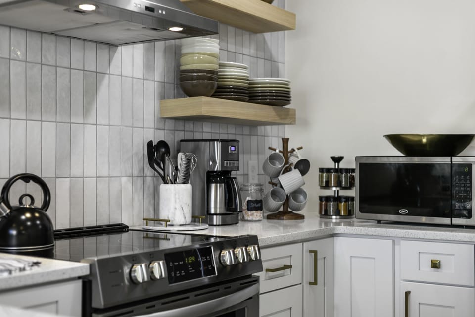 Electric stove + oven, drip coffee maker (coffee provided) and microwave.
