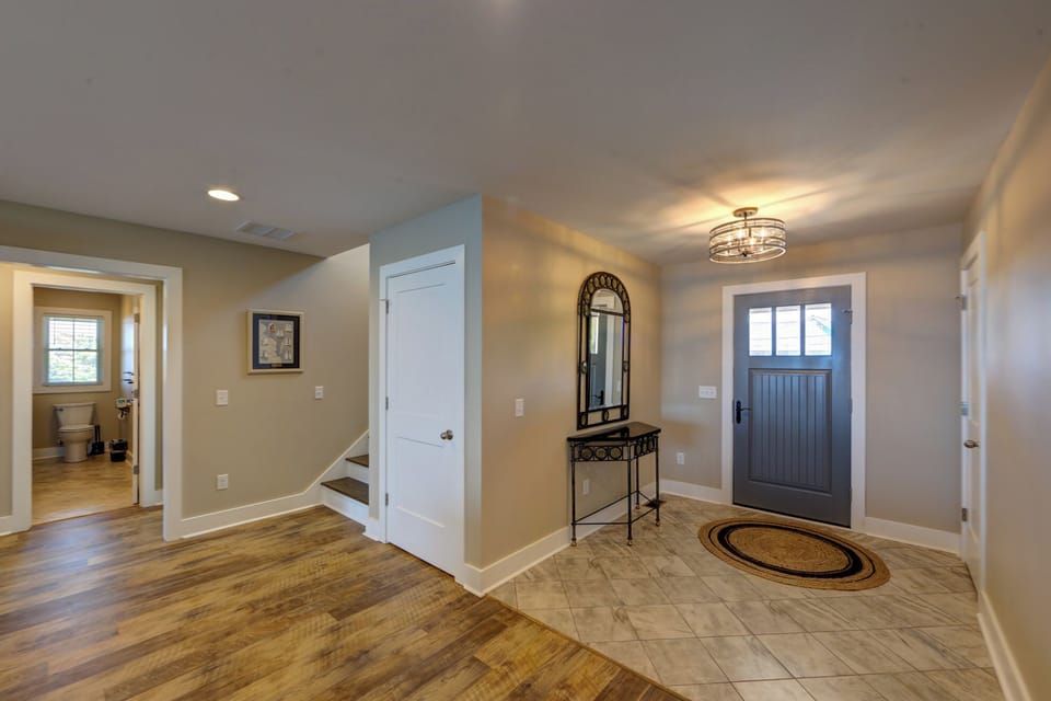 Step into your welcoming entryway with gleaming hardwood floors, elegant lighting, and thoughtful touches that make you feel at home the moment you arrive.