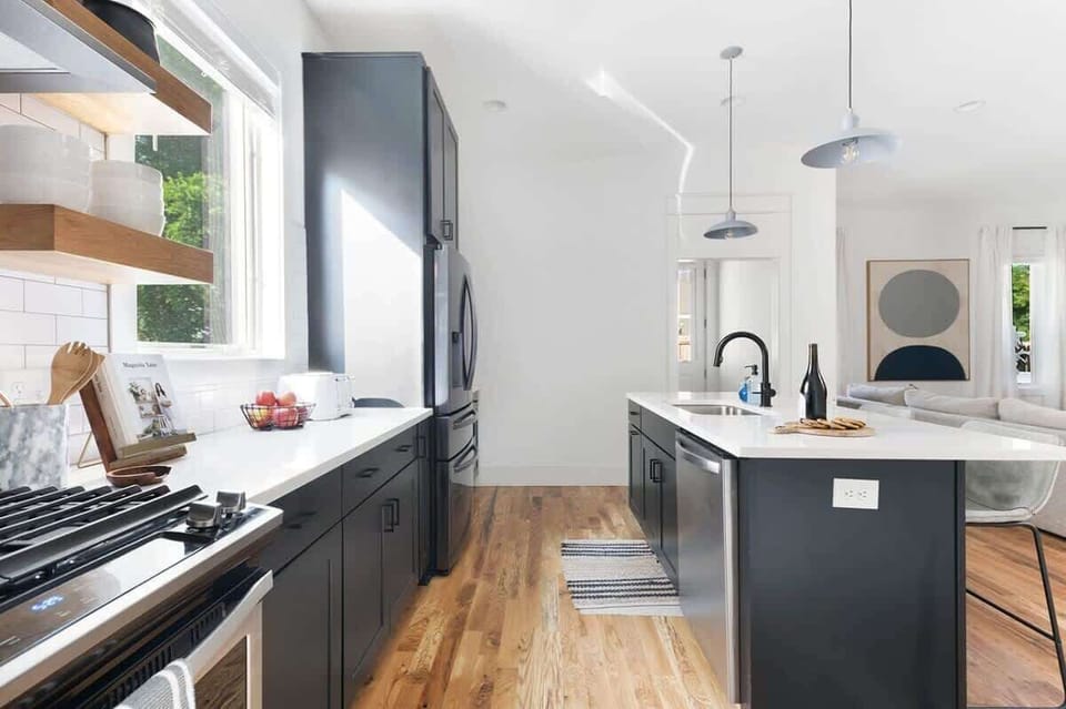 The kitchen features clear sightlines into the living room, enhancing the flow of conversation and creating a more open space.