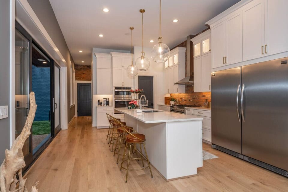 Kitchen with counter top seating for 4 and easy access to outdoor patio!