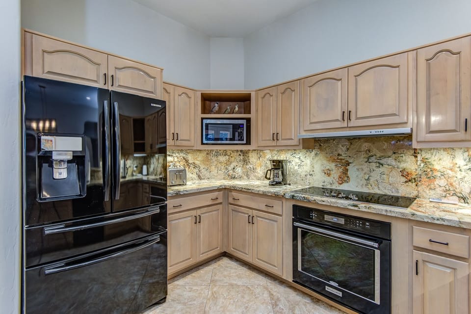 Black Stainless Appliances Including a 5-Burner Electric Stovetop