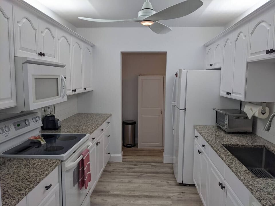 Kitchen view looking out to the pantry/cleaning closet, which leads to Laundry & uncover outside BBQ/dining area.