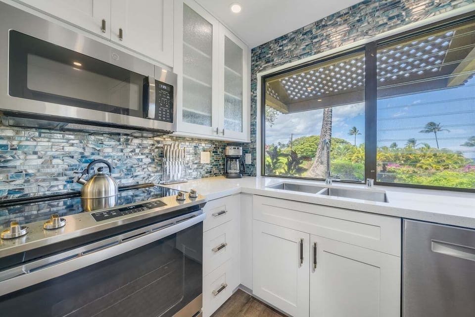 Cook in kitchens bright with mosaic tiles and palm views.