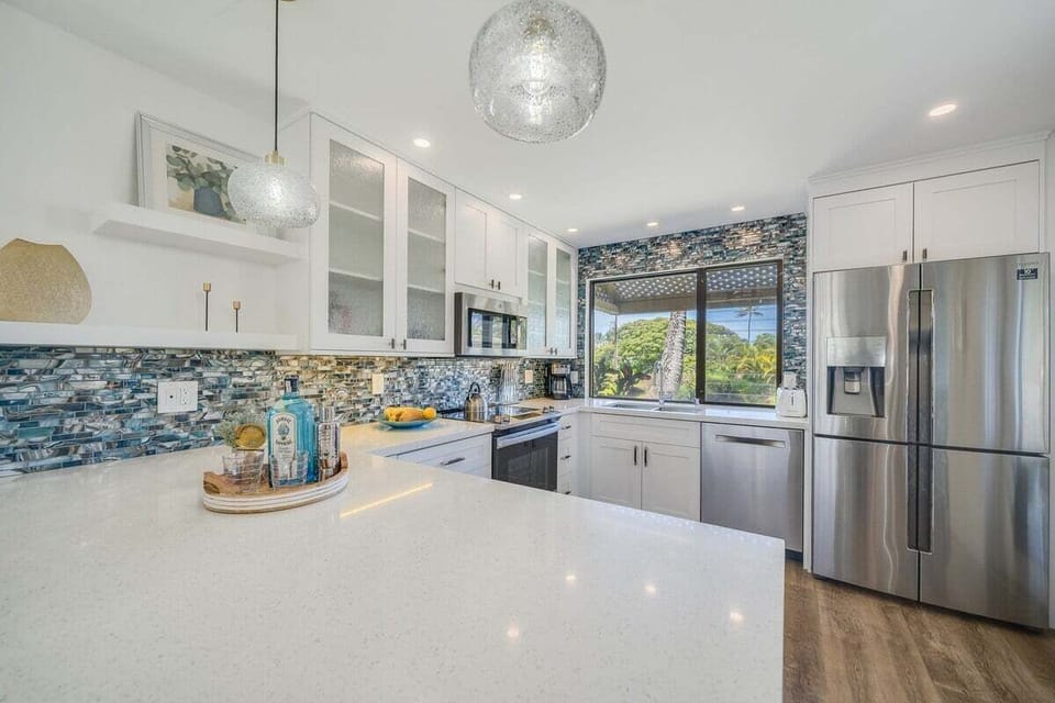 Cook in sleek kitchens lit by pendants and mosaic tiles.
