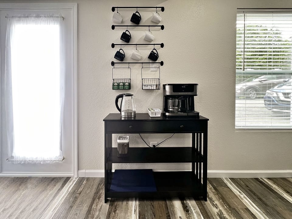A small coffee bar with coffee pot that will do pods or a full pot.