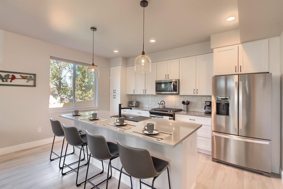 - Fully equipped kitchen features stainless steel appliances and sleek quartz counters
- Breakfast bar with seating for four is perfect for coffee, snacks, or casual meals