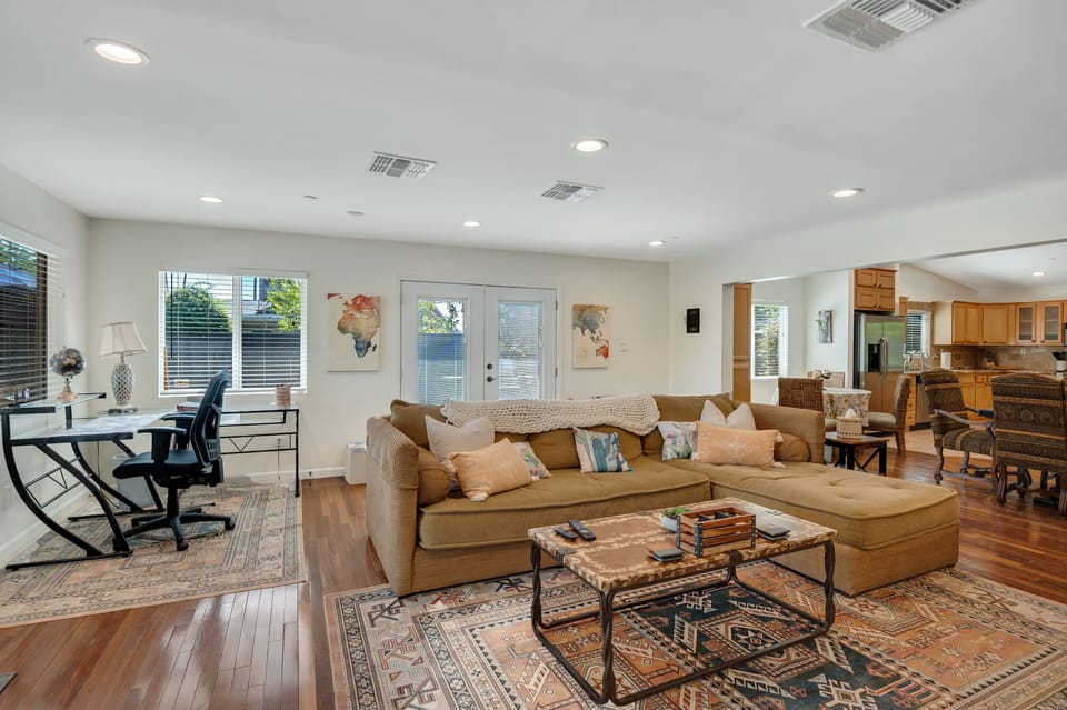 Lovely open living space with desk and side yard double doors