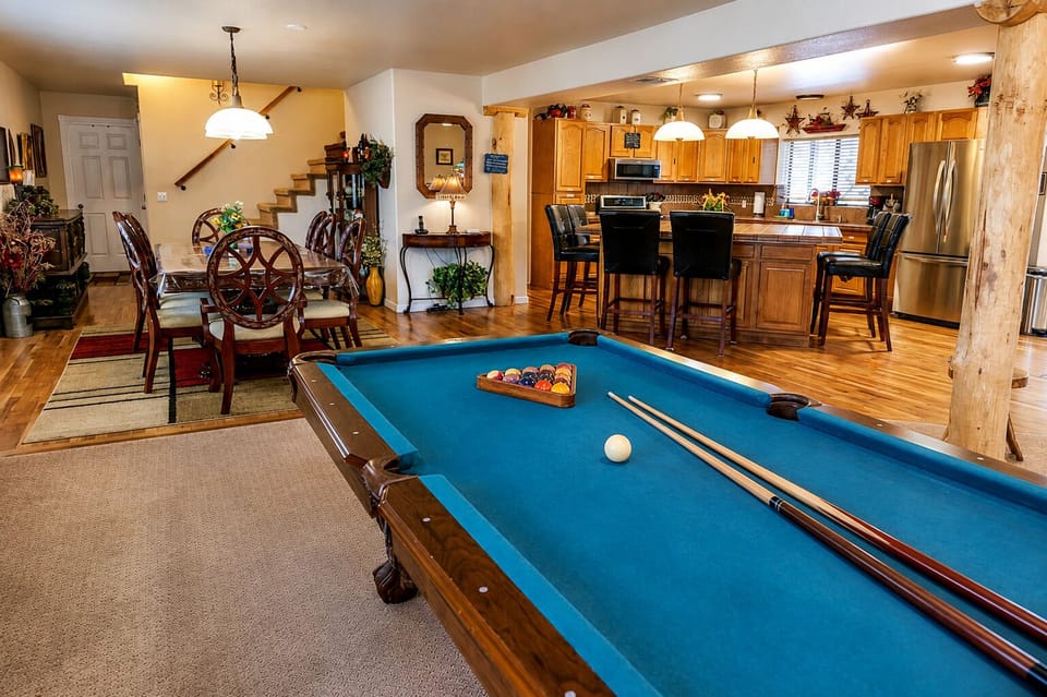 Great room (main level) with pool table, kitchen, and dining