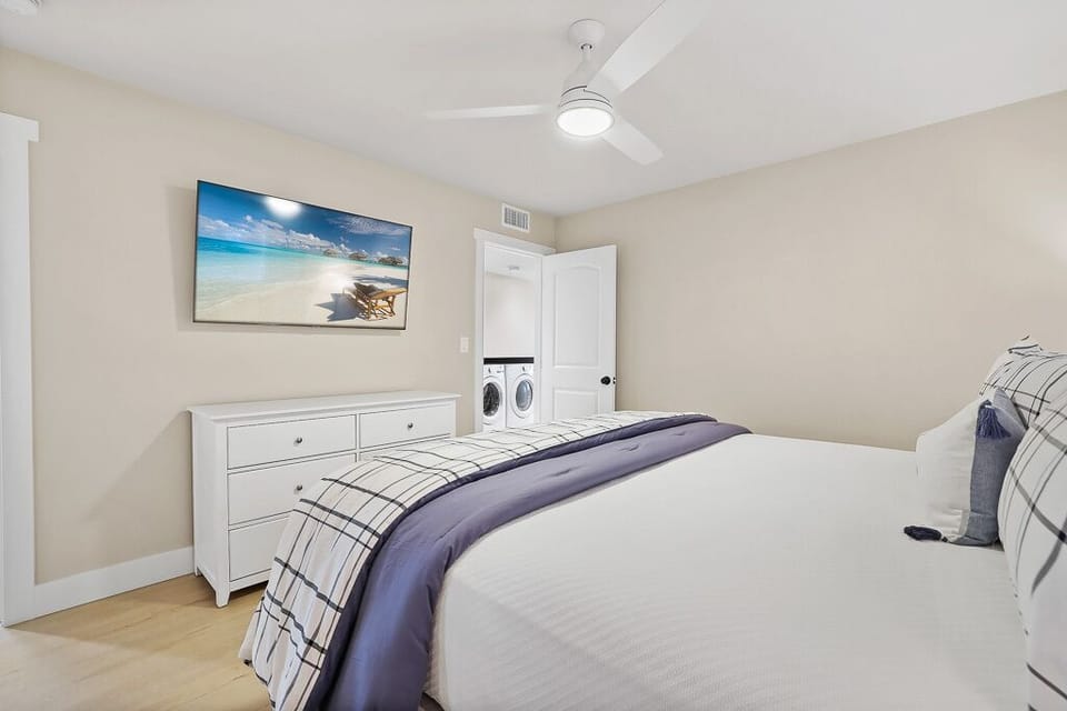 Inviting maser bedroom with king bed and TV