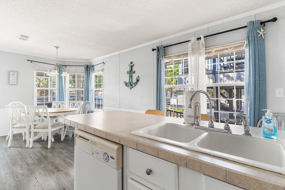 Bright kitchen and dining area with coastal charm and natural light