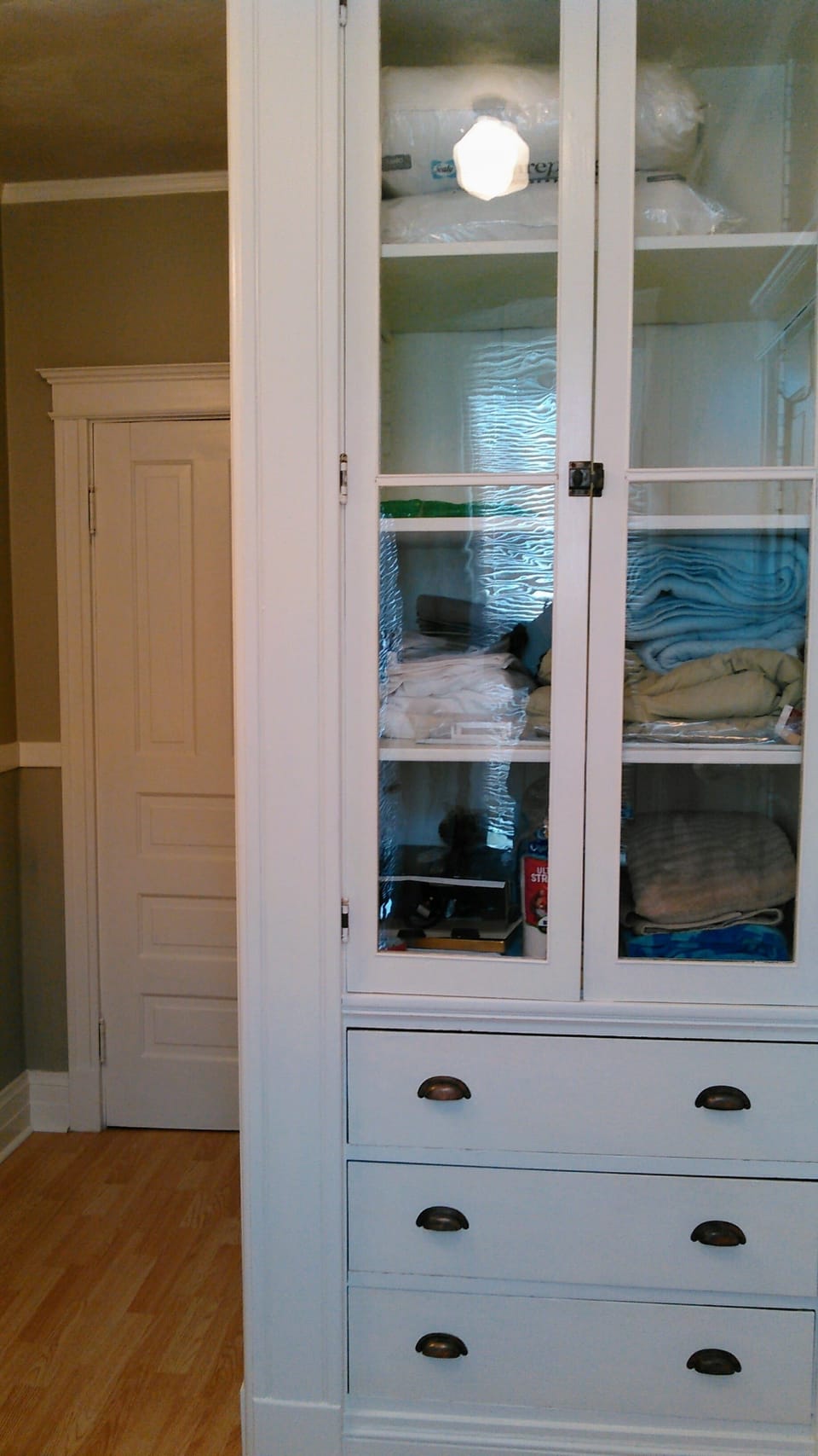 Large storage cabinet for extra blankets, pillows, sheets, towels, beach towels