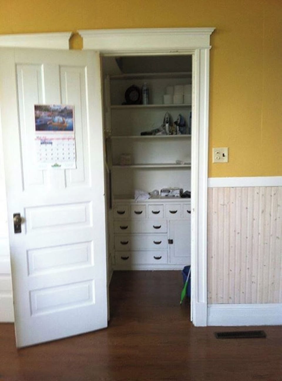 Large pantry access from kitchen next to basement stairs