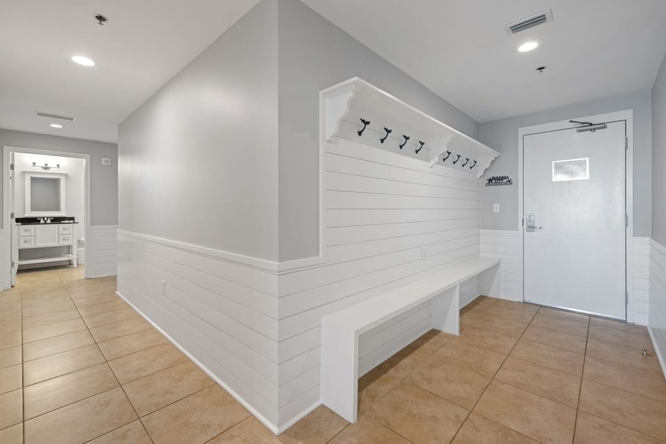 Stay organized even on vacation! This 10+ foot long hallway built-in provides plenty of storage to hang your beach bags, put up your keys on the custom "Panama City" key holder and store your flip flops.