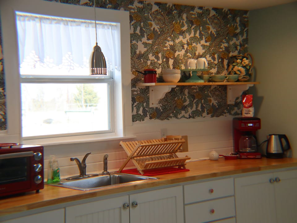 Light and airy kitchenette with custom cabinets and beautiful decor.