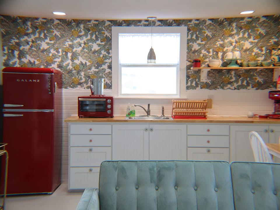 The living room & kitchenette share a roomy, cozy, and classy space.