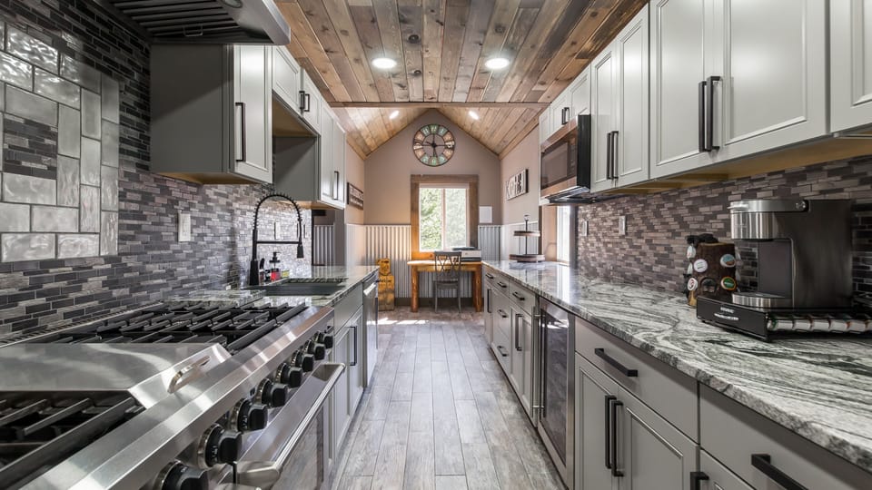 This Galley Kitchen's gleaming granite countertops and Chef's Stove will ignite your culinary creativity.