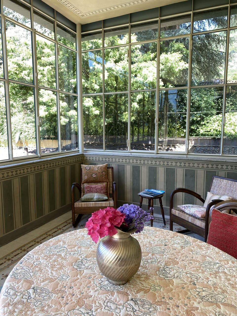 The Clematide veranda nestled on the first floor, surrounded by trees. 
