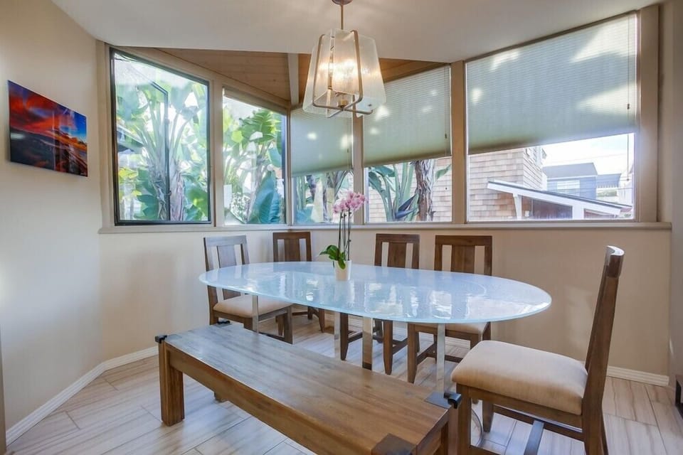 Dining for 6 at this spacious table surrounded by windows.