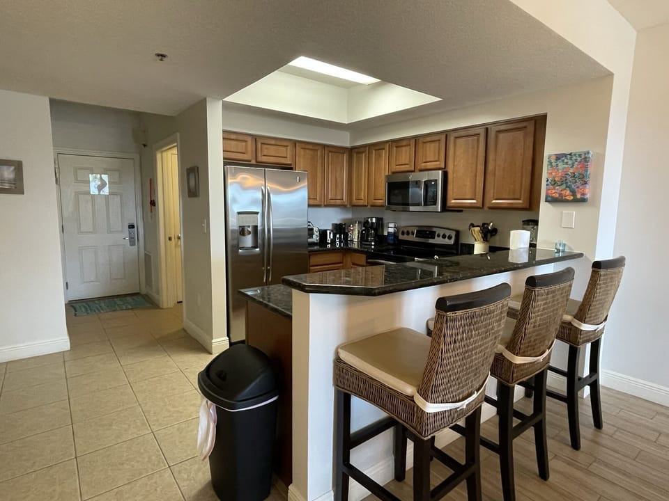 Well-equipped Stainless Steel Kitchen with bar area
