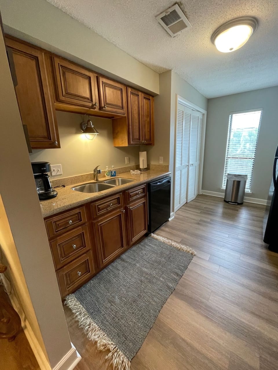 Another view of the galley kitchen- sink with disposal and dishwasher.