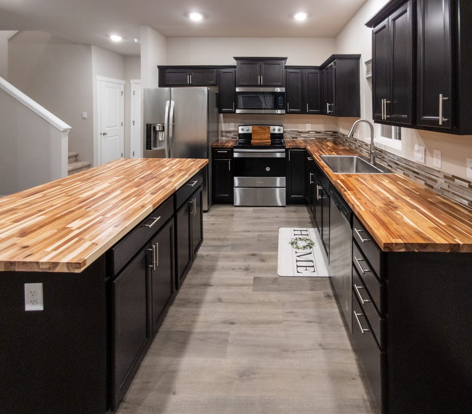 Beautiful kitchen featuring butcher block counters & stainless-steel appliances