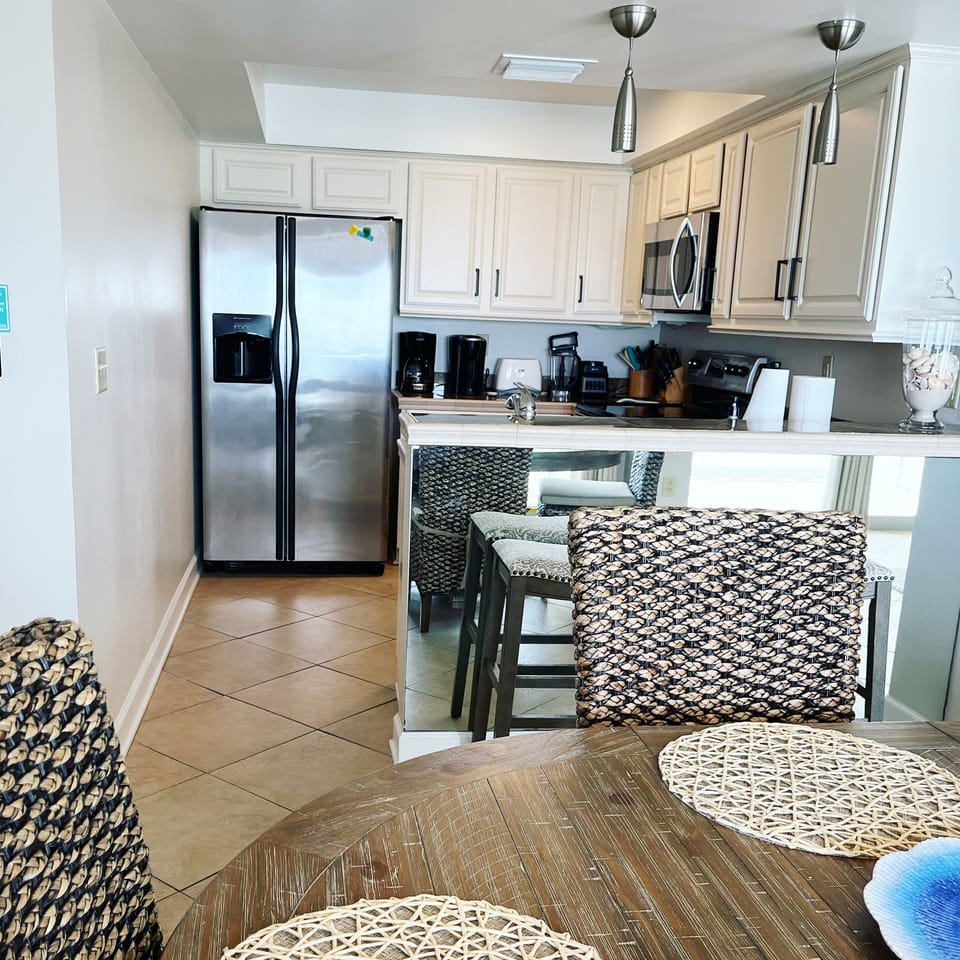 Full kitchen with a bar and bar stools