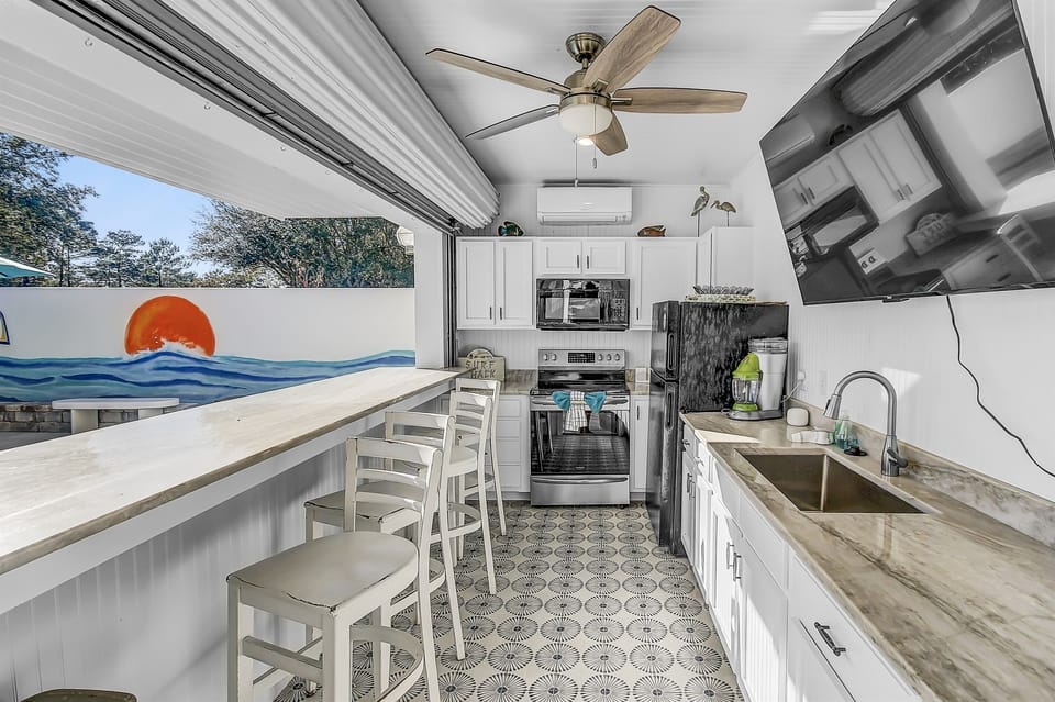 Outside Cabana Kitchen - Enjoy sun-soaked days by your private pool and gather for al fresco entertainment at the outdoor cabana kitchen with a spacious TV. There are two margarita machines and a refrigerator for chilling your drinks!