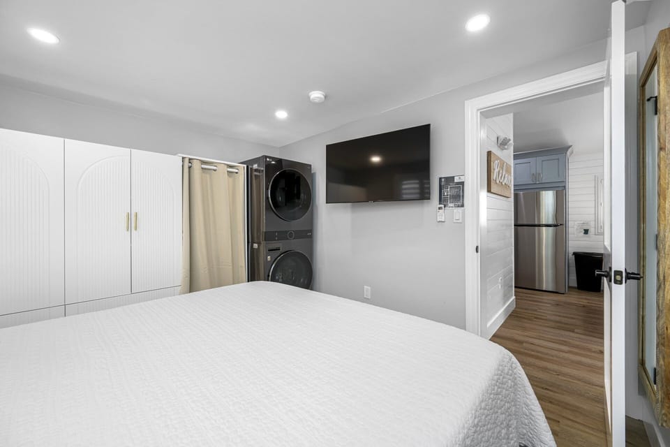 Elegant master bedroom with convenient access to the laundry area.