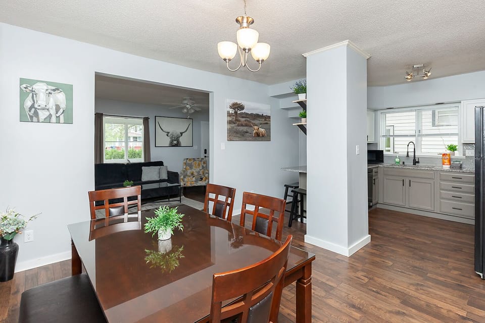 Dining area & kitchen. Table seating for 6 people, with 3 more at the bar