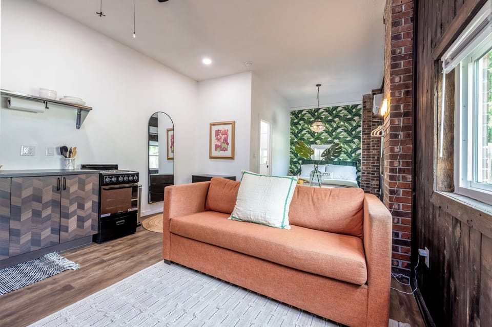 The orange couch converts into a queen pull out bed