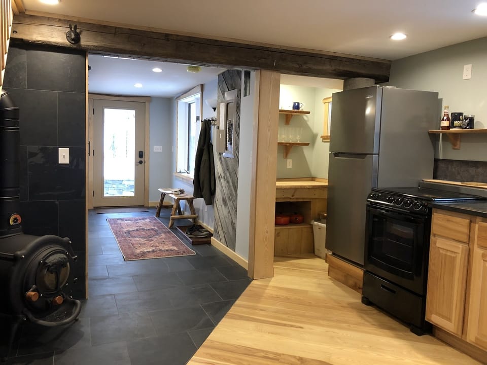 View of front door from dining room, bathroom is on the left off hallway