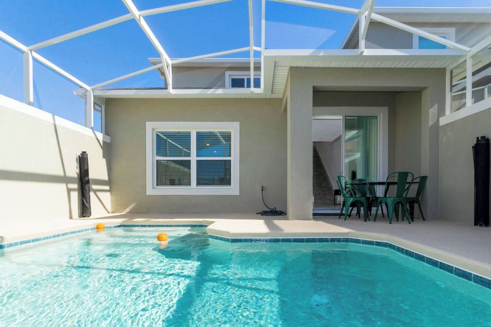 Private screened pool oasis with sparkling water, sunny patio space, and a relaxed outdoor dining nook-made for splashy fun and warm-weather unwinding!