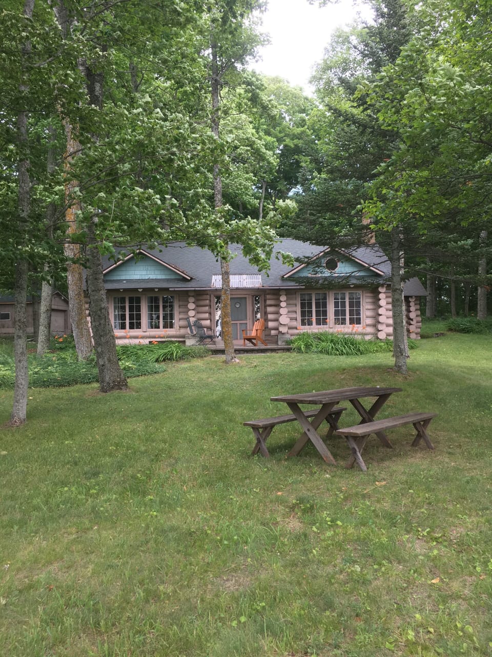 front of the cabin, facing the lake