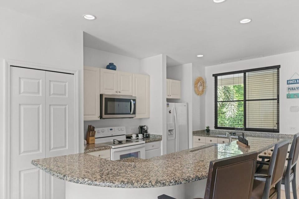 The large kitchen has plenty of storage space and breakfast bar seating.