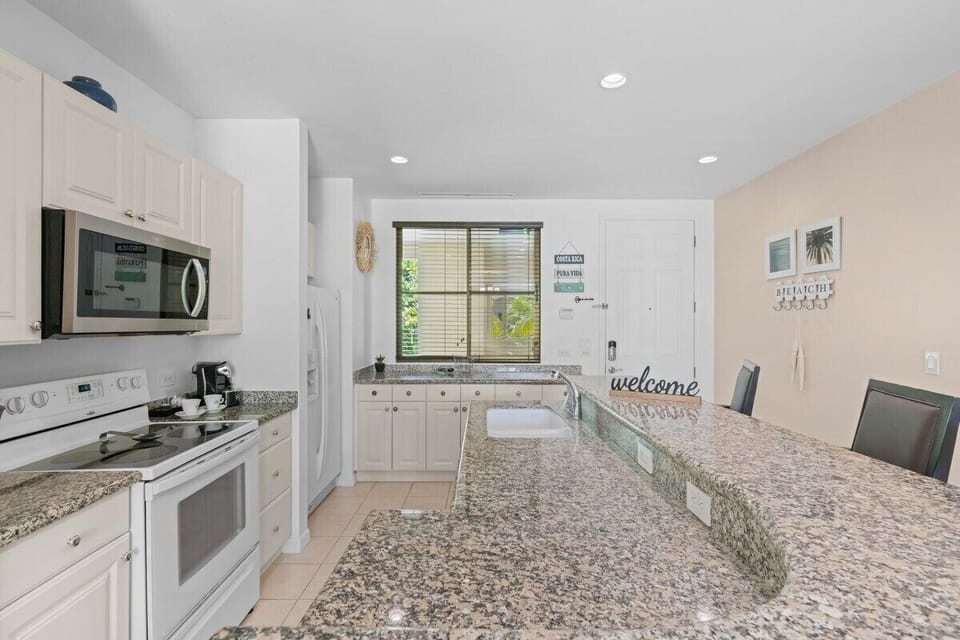 The large kitchen has plenty of storage space and breakfast bar seating.