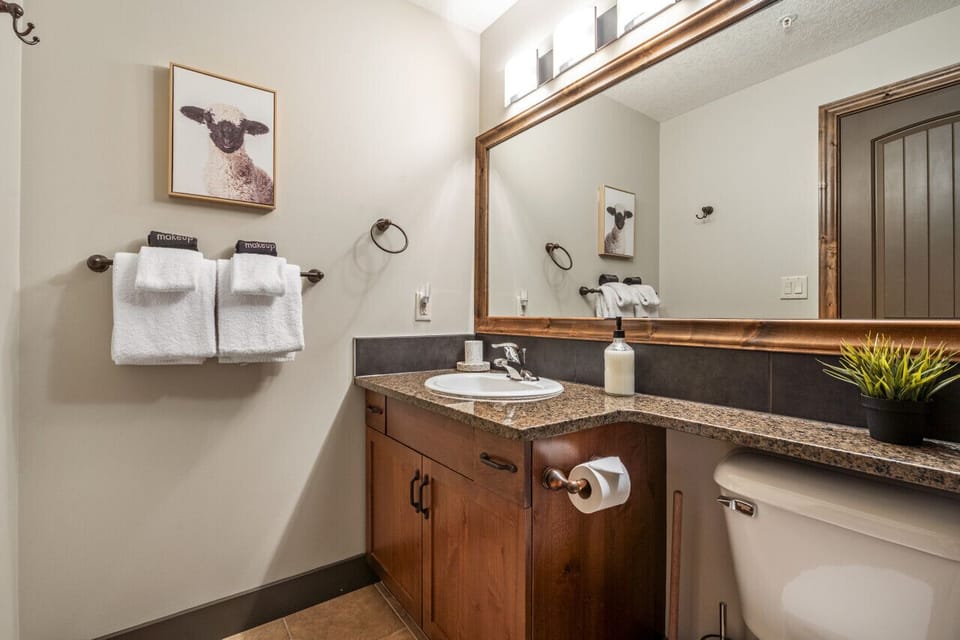 Primary ensuite full bathroom with a shower/tub combo.  Each bathroom comes stocked with towels, a hair dryer, shampoo, conditioner & body wash.