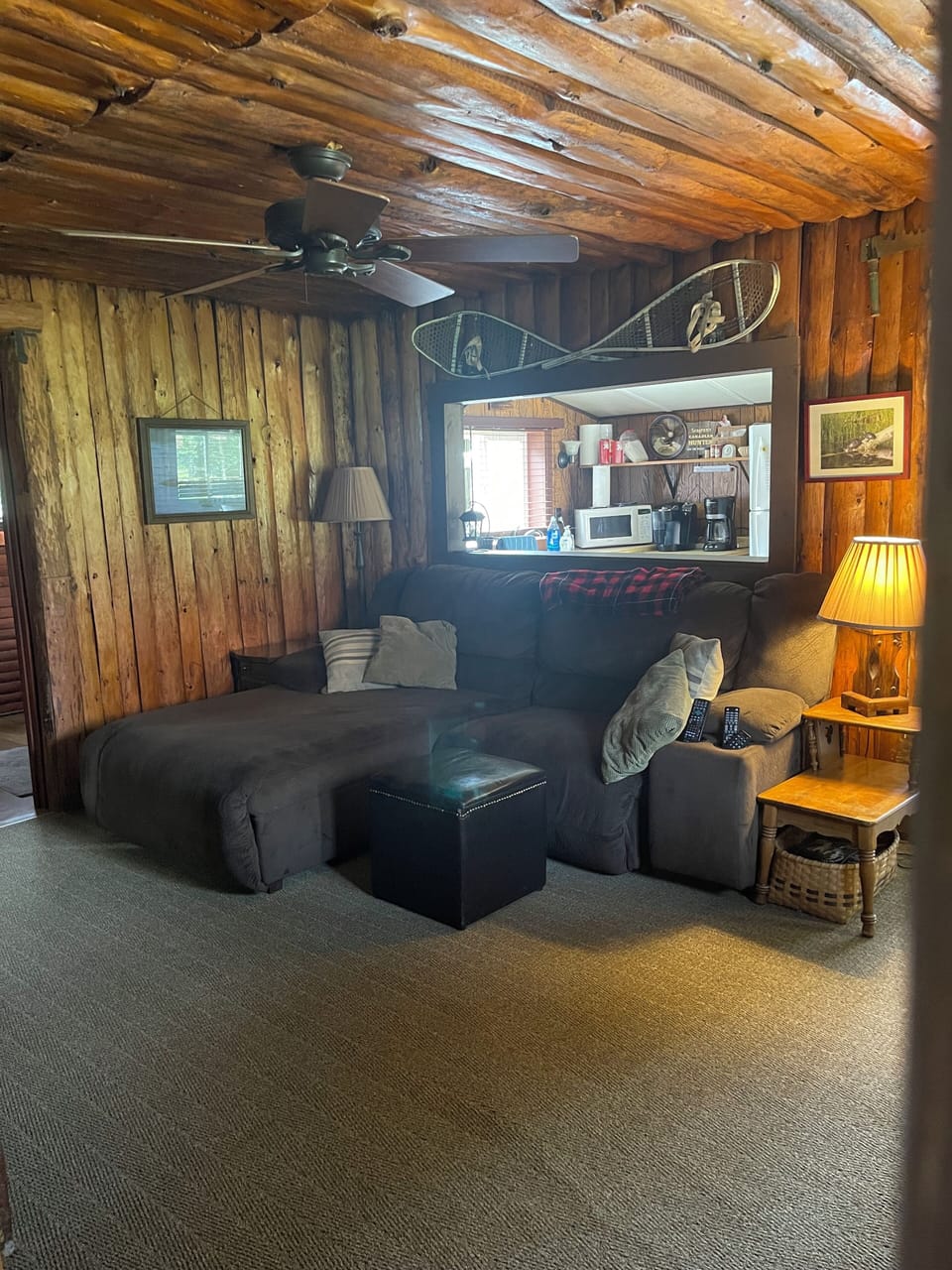 Cabin 5 living room with sofa that reclines on one side
