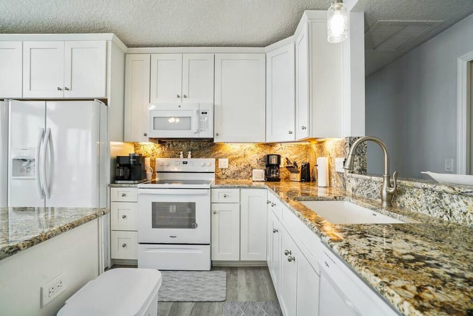 Bright and white! The view is the focal point of this house and can be seen from any point in the kitchen