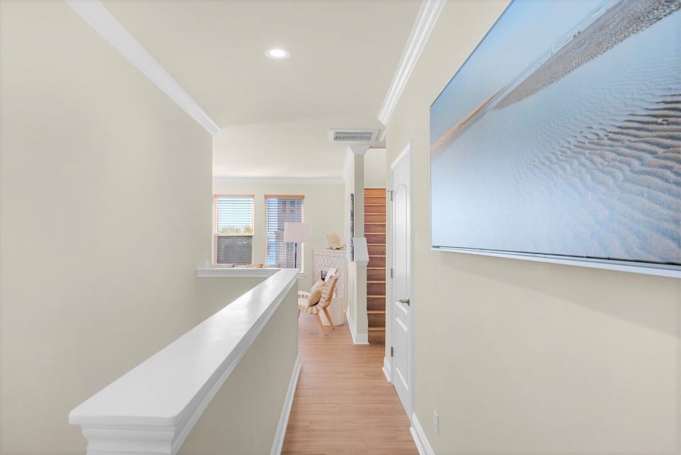 2nd floor.  Hall corridor flowing to ocean view living room and balcony.