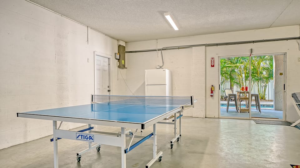 Cabana room right off the pool with ping pong and cornhole — where friendly competitions happen daily.